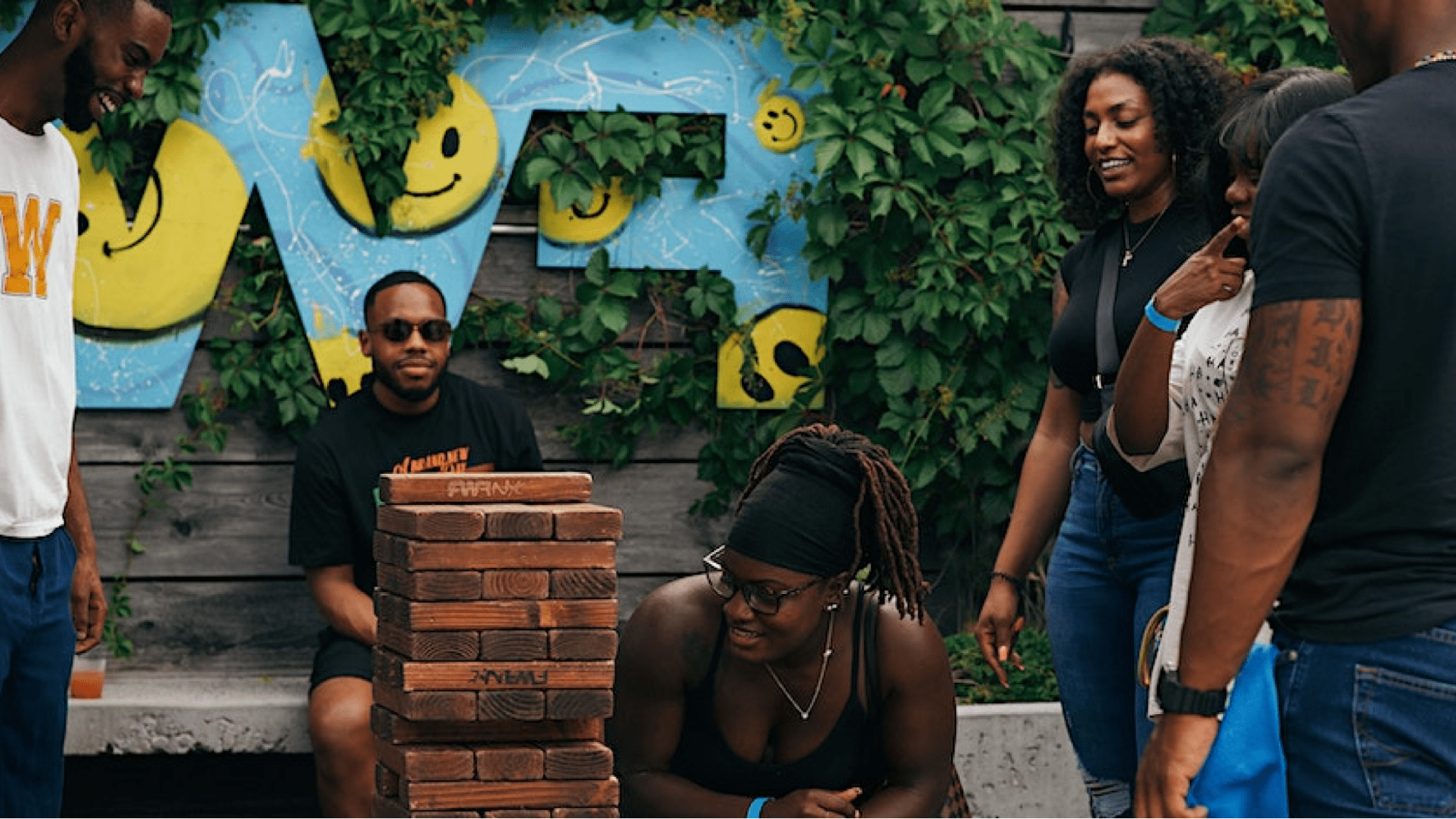 People playing giant jenga at a block party