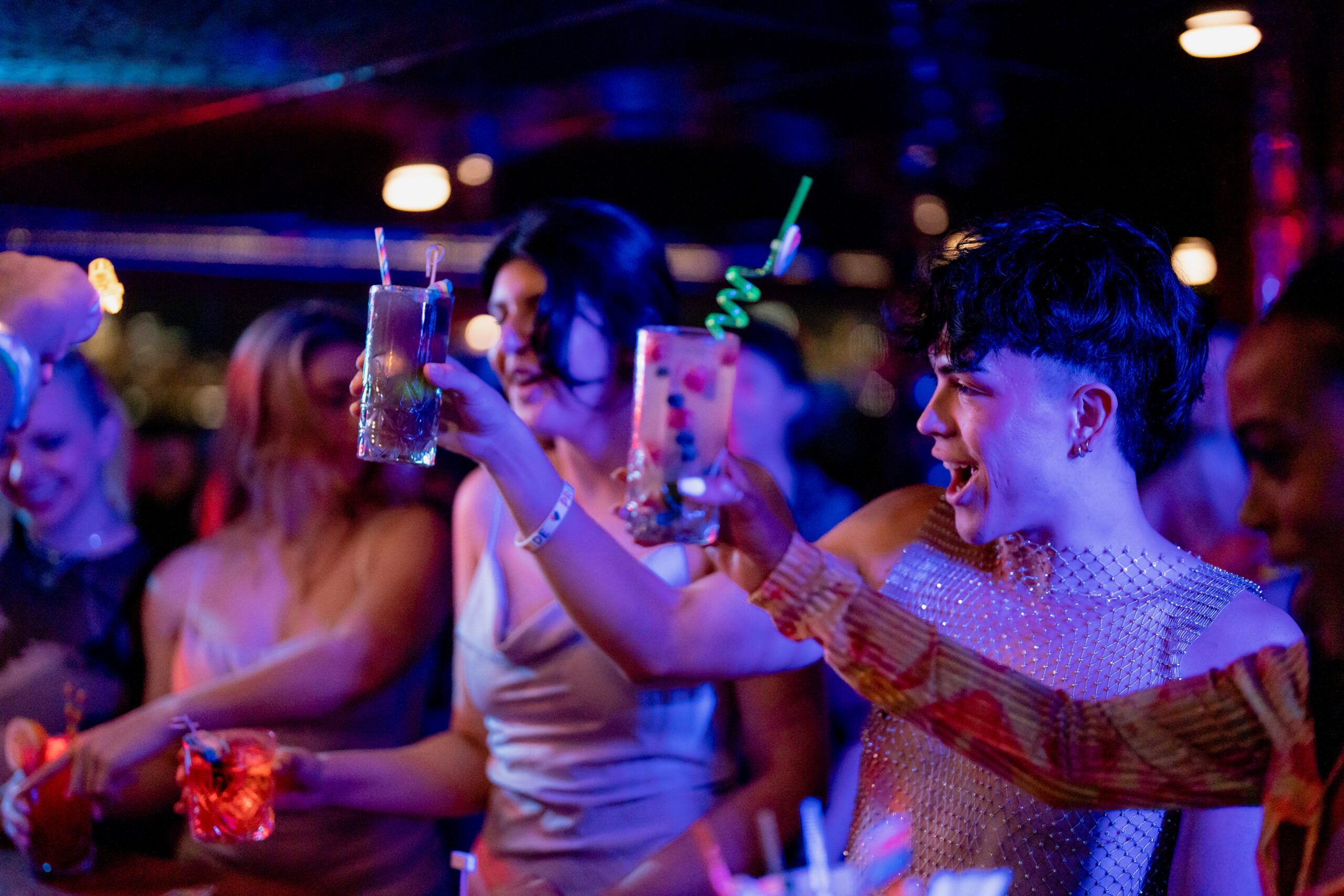 people with drinks at a bar